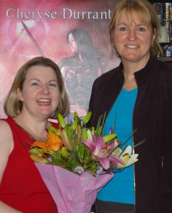 Fantasy author Louise Cusack presents me with flowers to celebrate the launch of The Blood She Betrayed